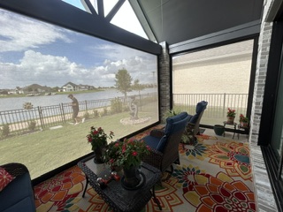 Covered outdoor seating area with retractable shades